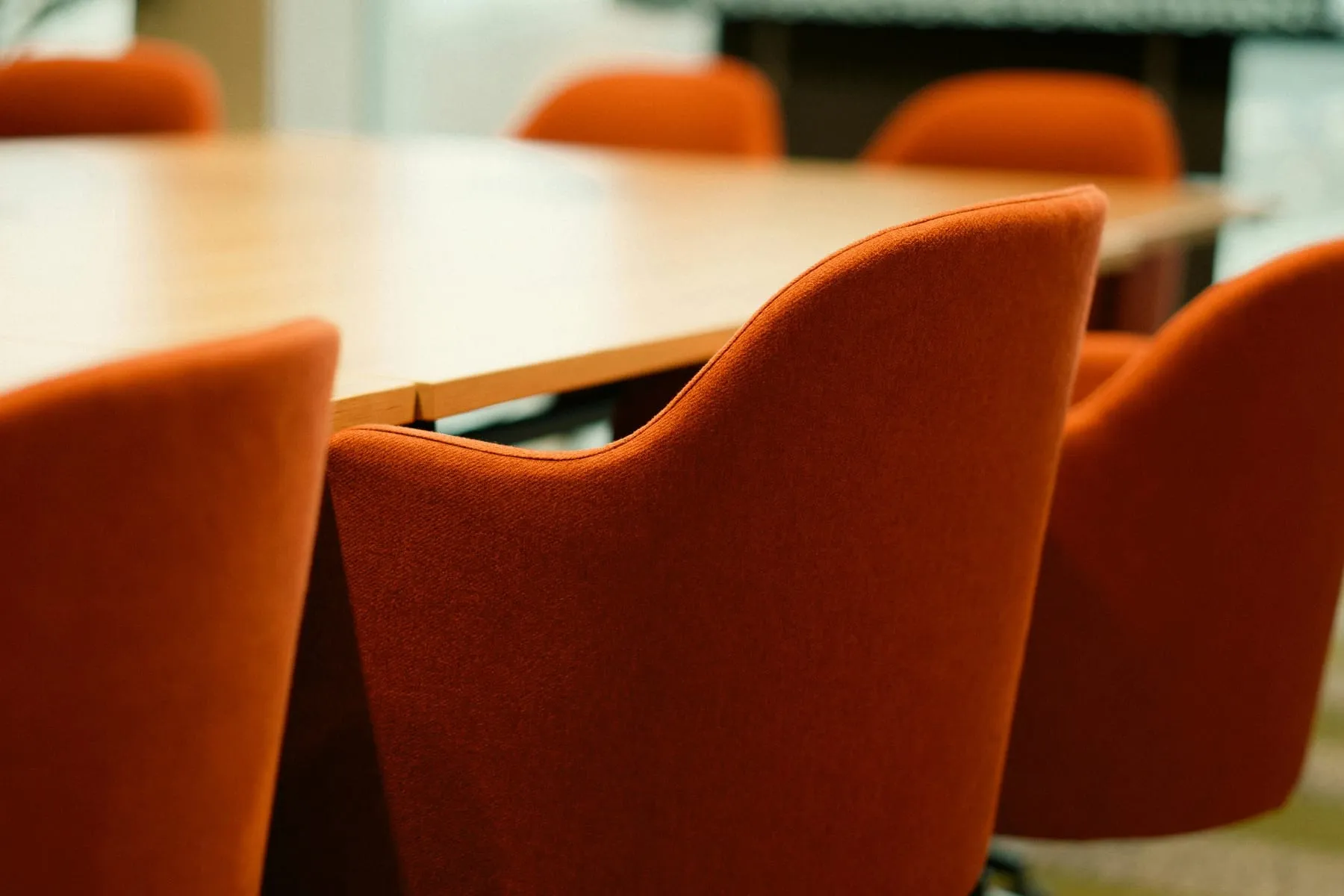 A high-rise commercial boardroom with city views, set for a meeting