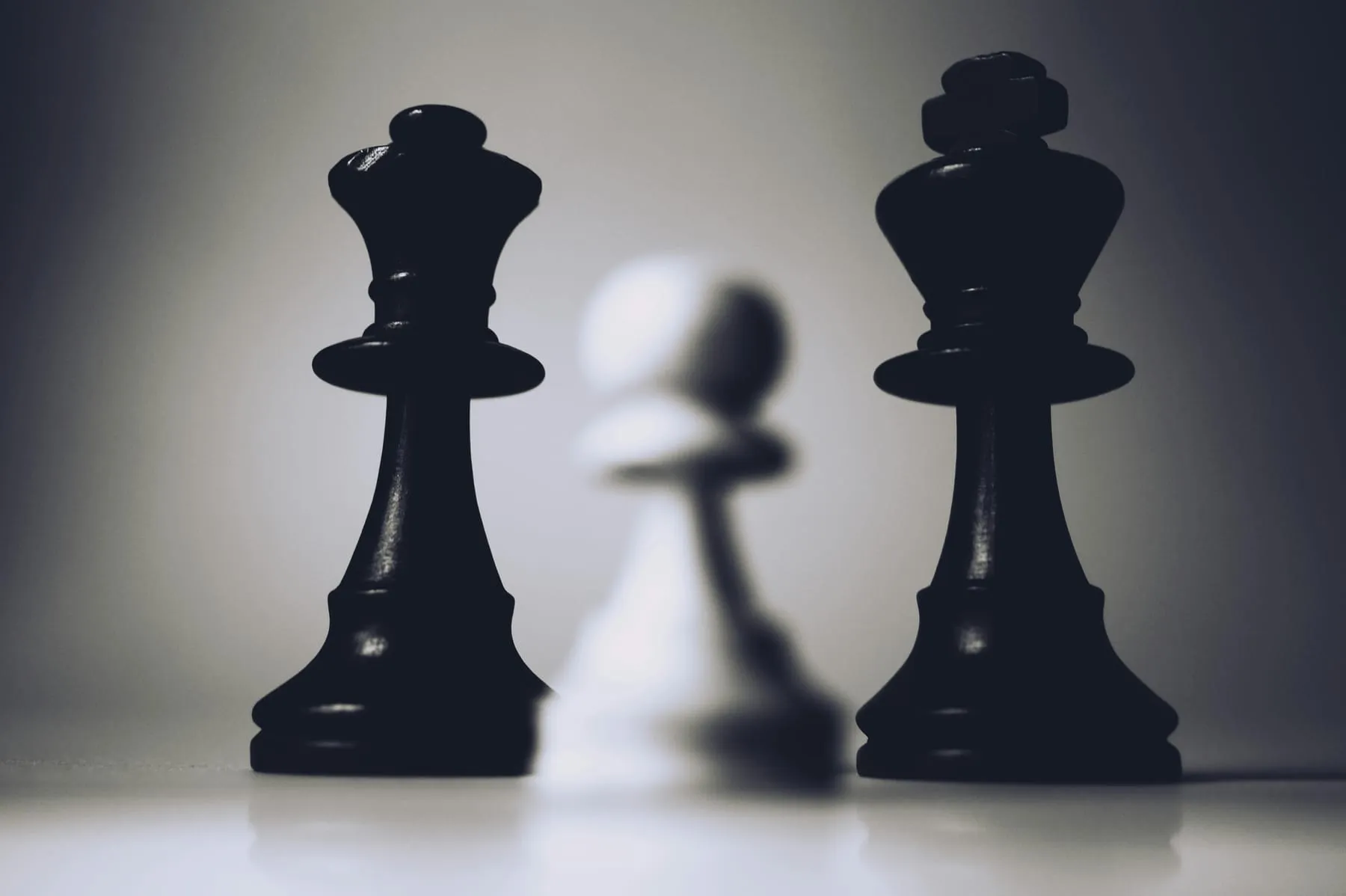 Two black chess pieces in sharp focus, a study in position and leverage